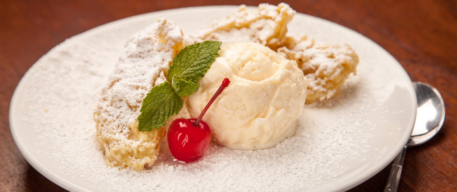 Ice cream on a plate with a cherry